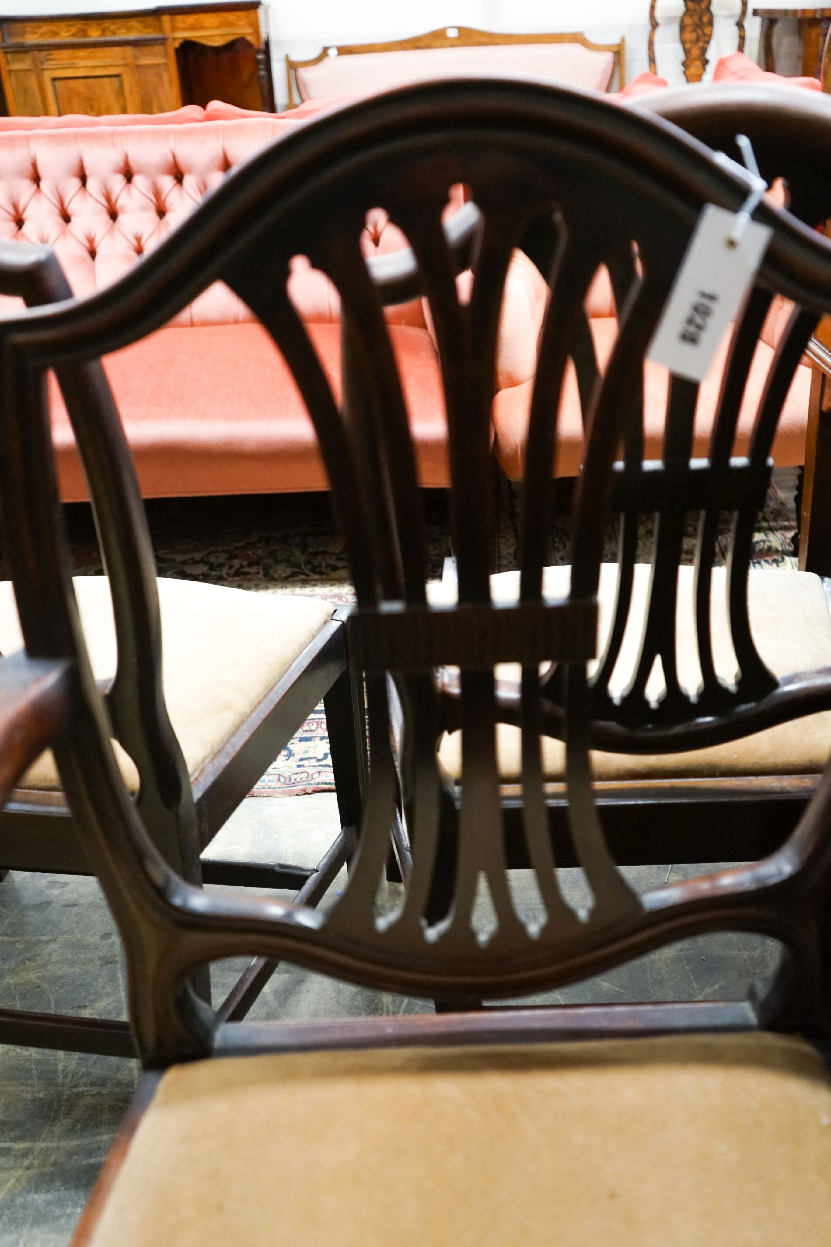 A set of six George III mahogany dining chairs (one with arms)